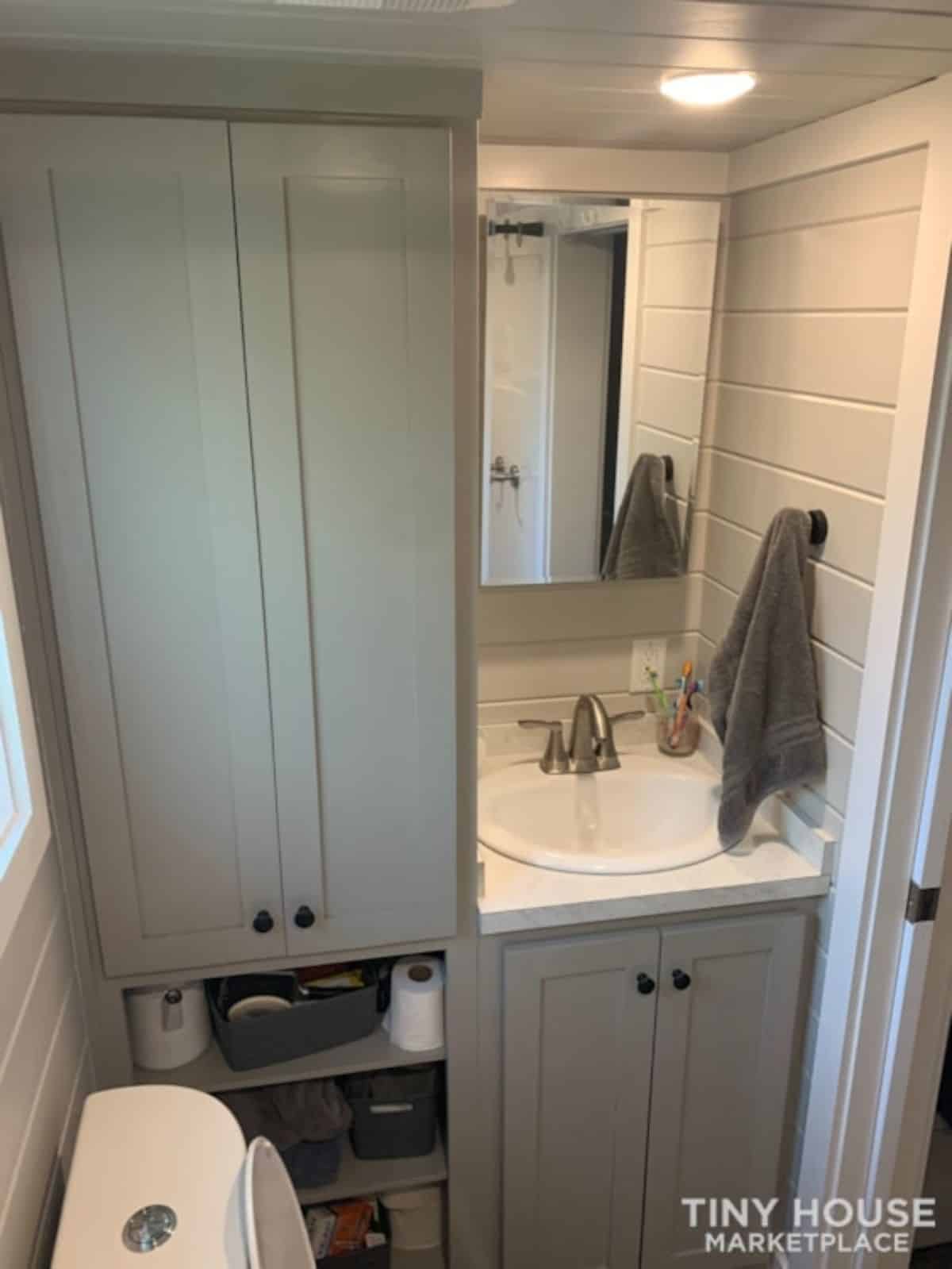 Sink cum vanity & mirror in bathroom of towable tiny home