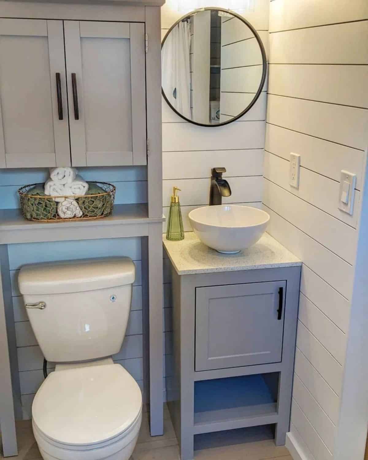 Standard toilet, sink with vanity & mirror in bathroom
