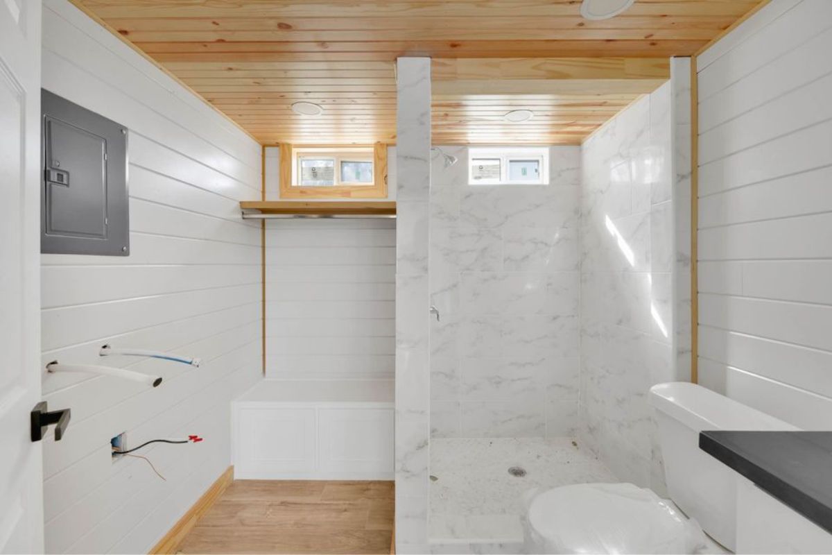 Bathroom of tiny house has a marble shower area