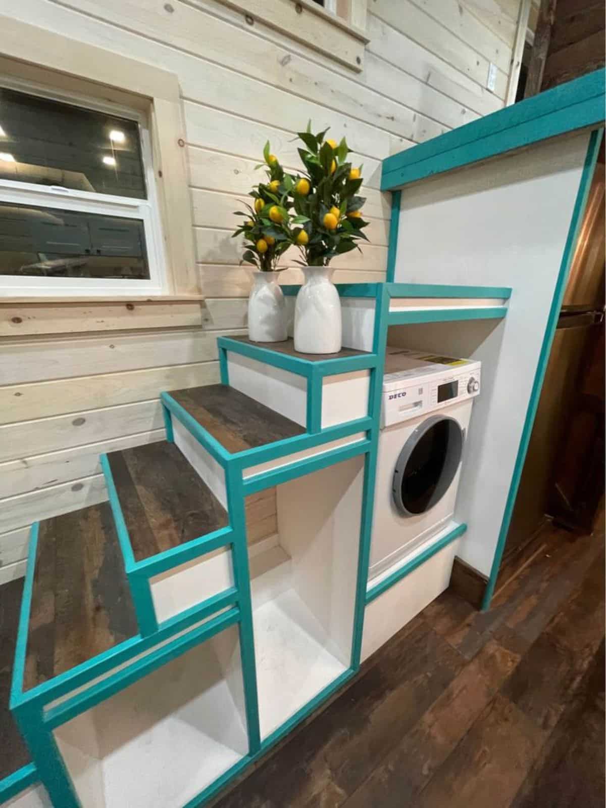 Multipurpose stairs with washer dryer combo underneath
