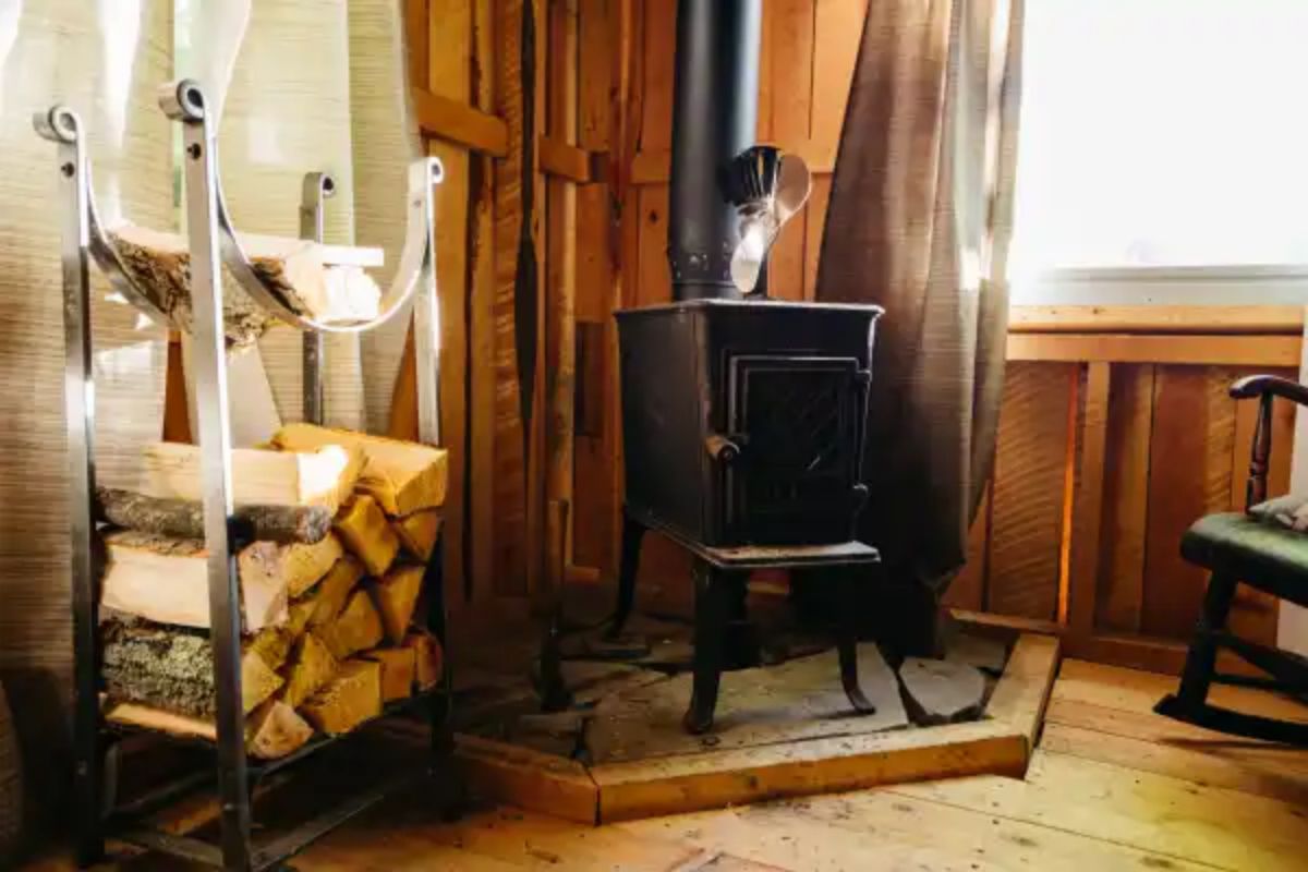 wood in stack beside black wood stove