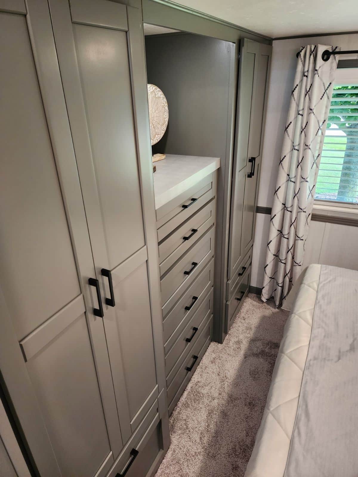 Gray cabinets in a bedroom of a tiny house.
