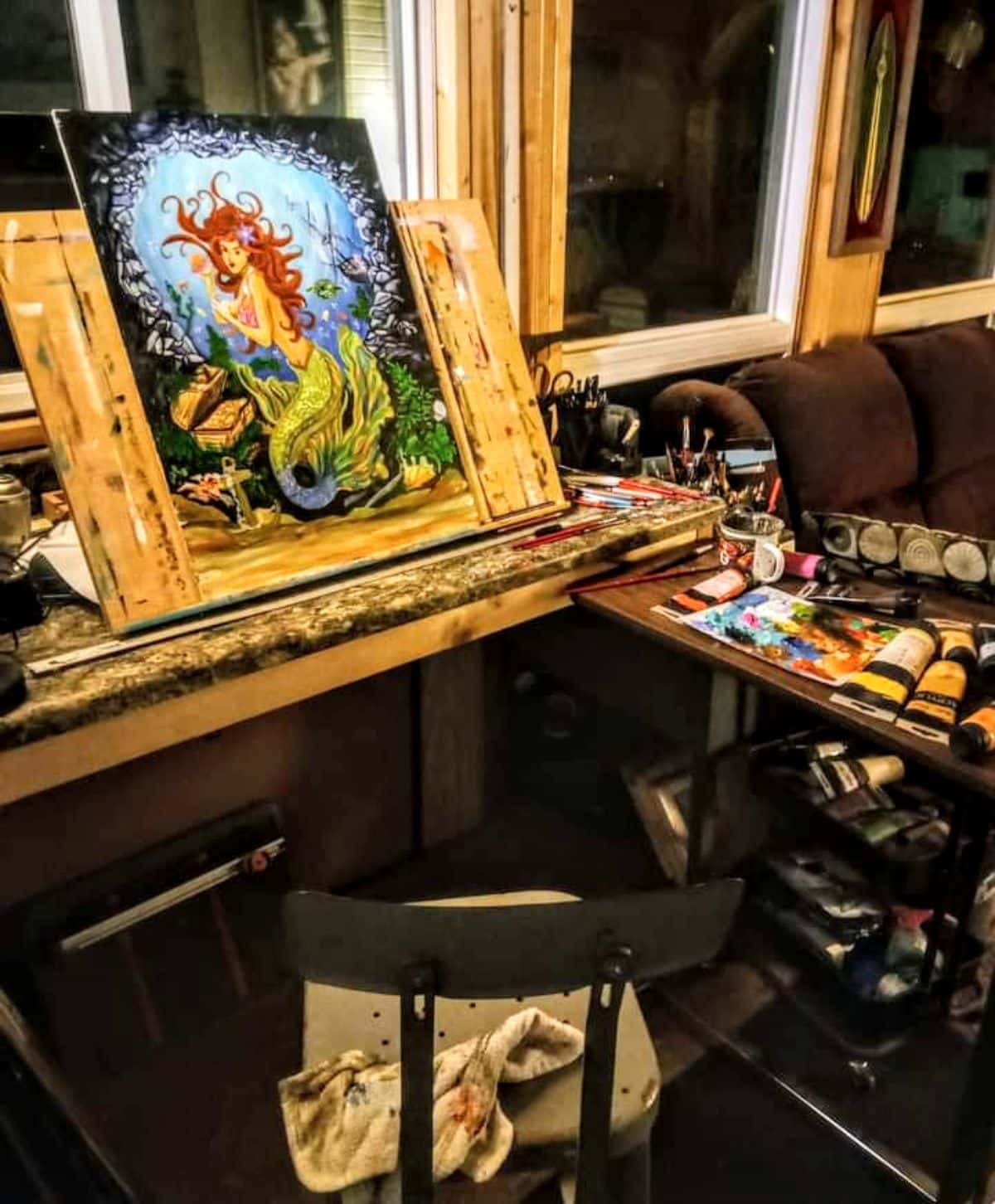 Ray’s Cabin Off-the-Grid Tiny House indoor with a mermaid painting.