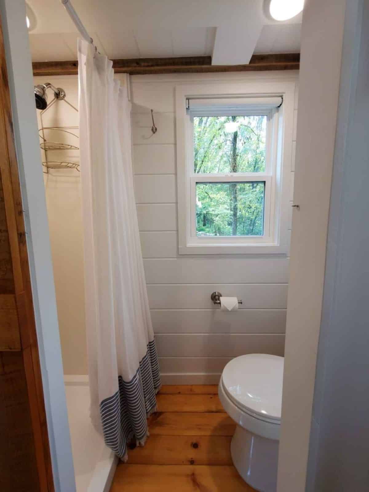 shower cubicle with curtain in bathroom