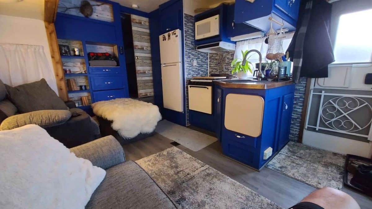Kitchen area of remodeled tiny home is compact