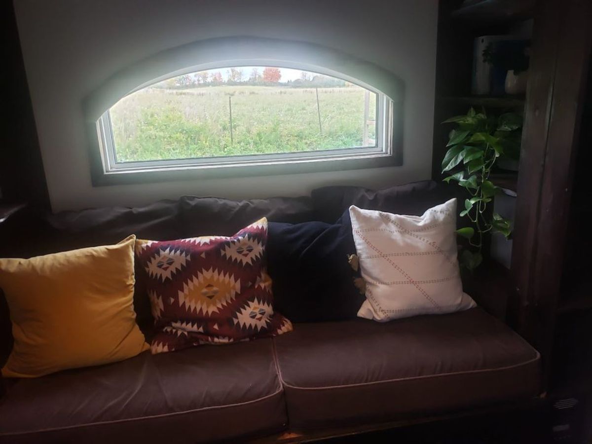 living area of off grid tiny home has a couch