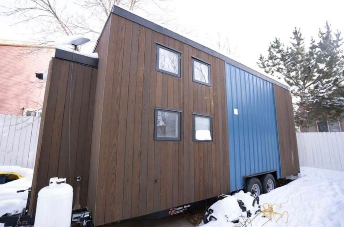 Stunning brown and blue exterior of 2 bedroom tiny house
