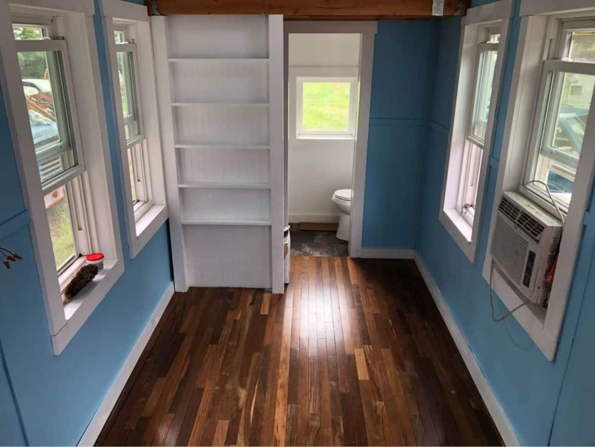 amazing flooring and blue colored walls of tumbleweed tiny home