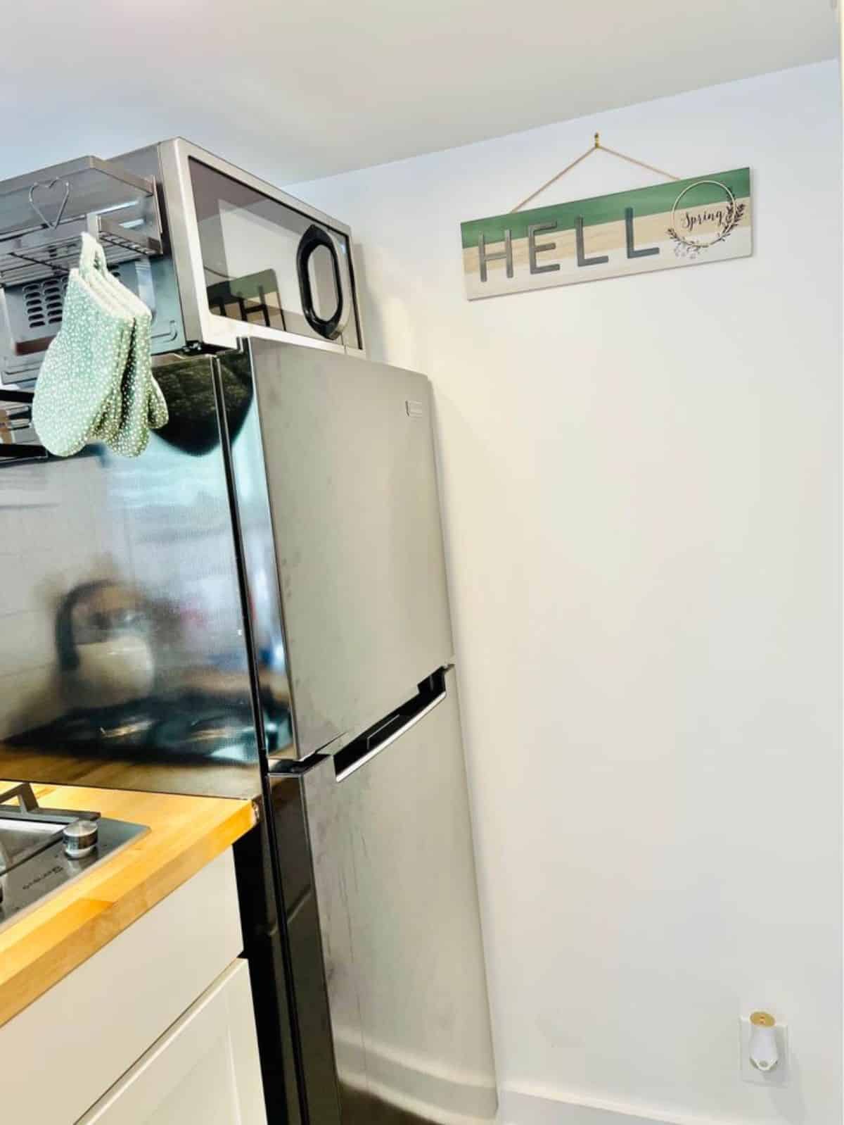 refrigerator included in the kitchen area of remodeled home on wheels