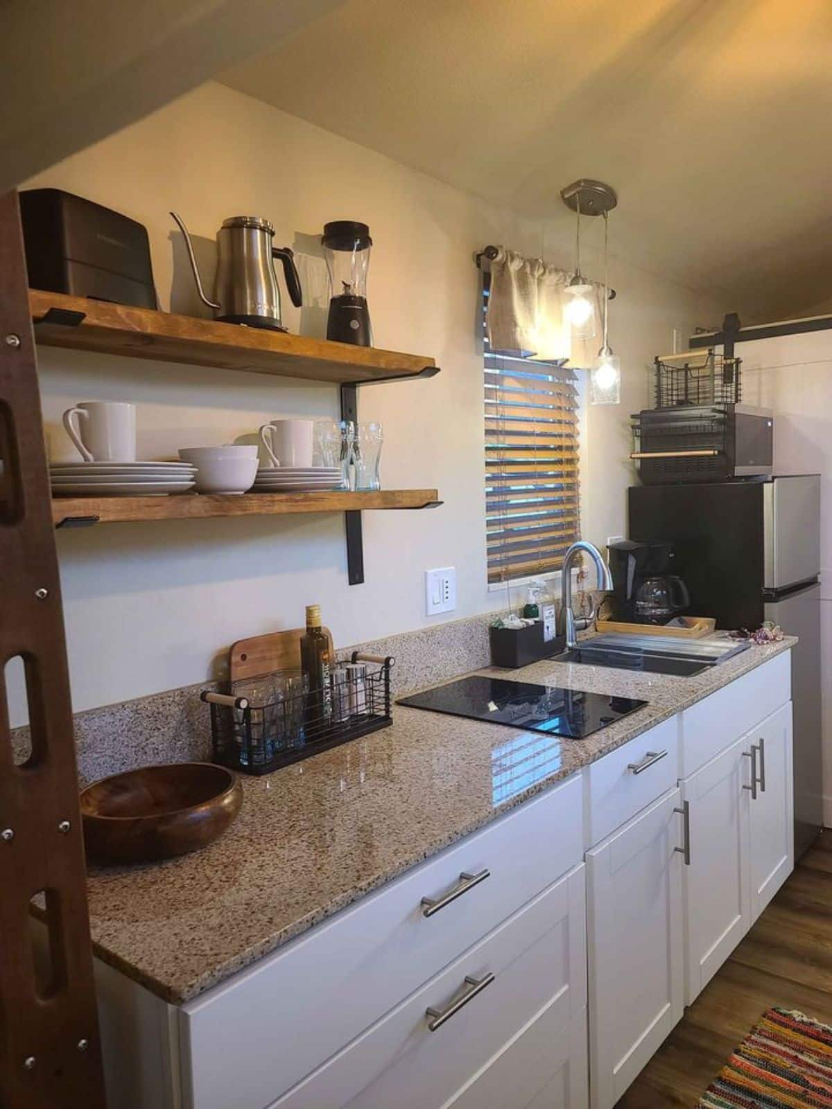 kitchen area of tiny house with deck is compact yet stylish