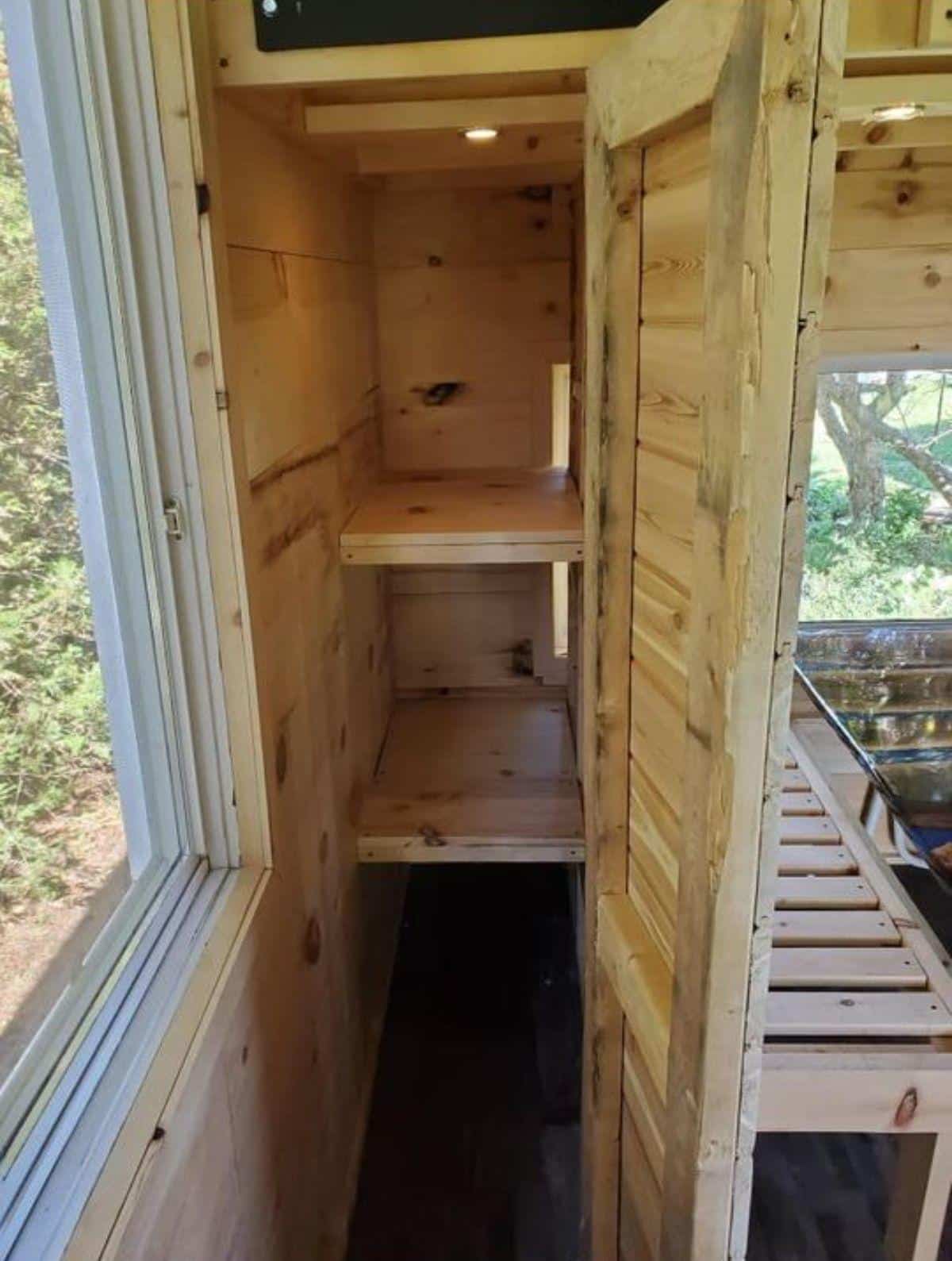 storage cabinets under the ,main loft of tiny cabin house