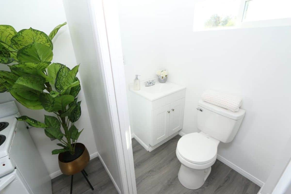 standard toilet, sink with vanity in bathroom
