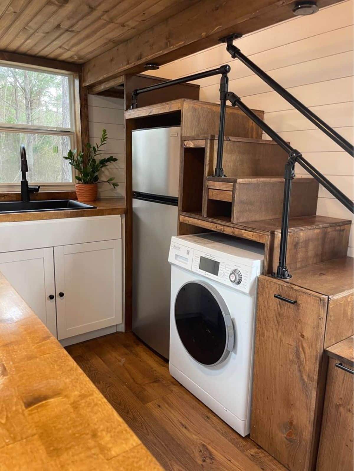 refrigerator and washer dryer combo in the kitchen