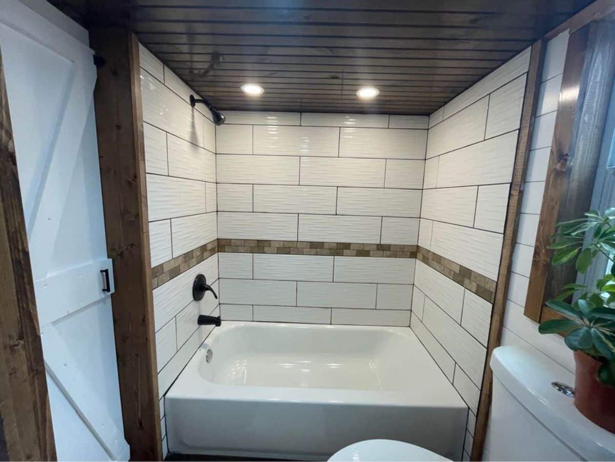bathtub in bathroom of 24’ tiny house on wheels
