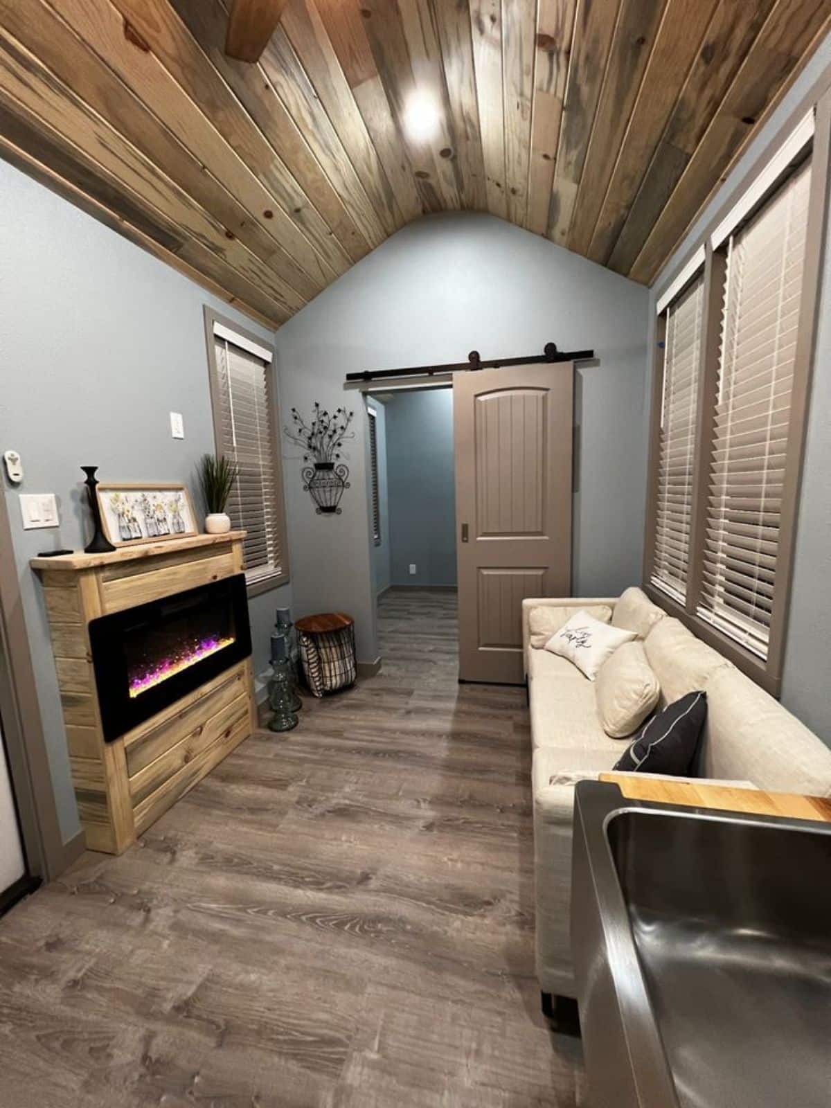 living area of tiny home with downstairs bedroom