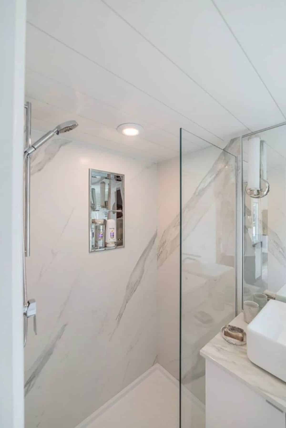 separate shower area with glass door in bathroom area