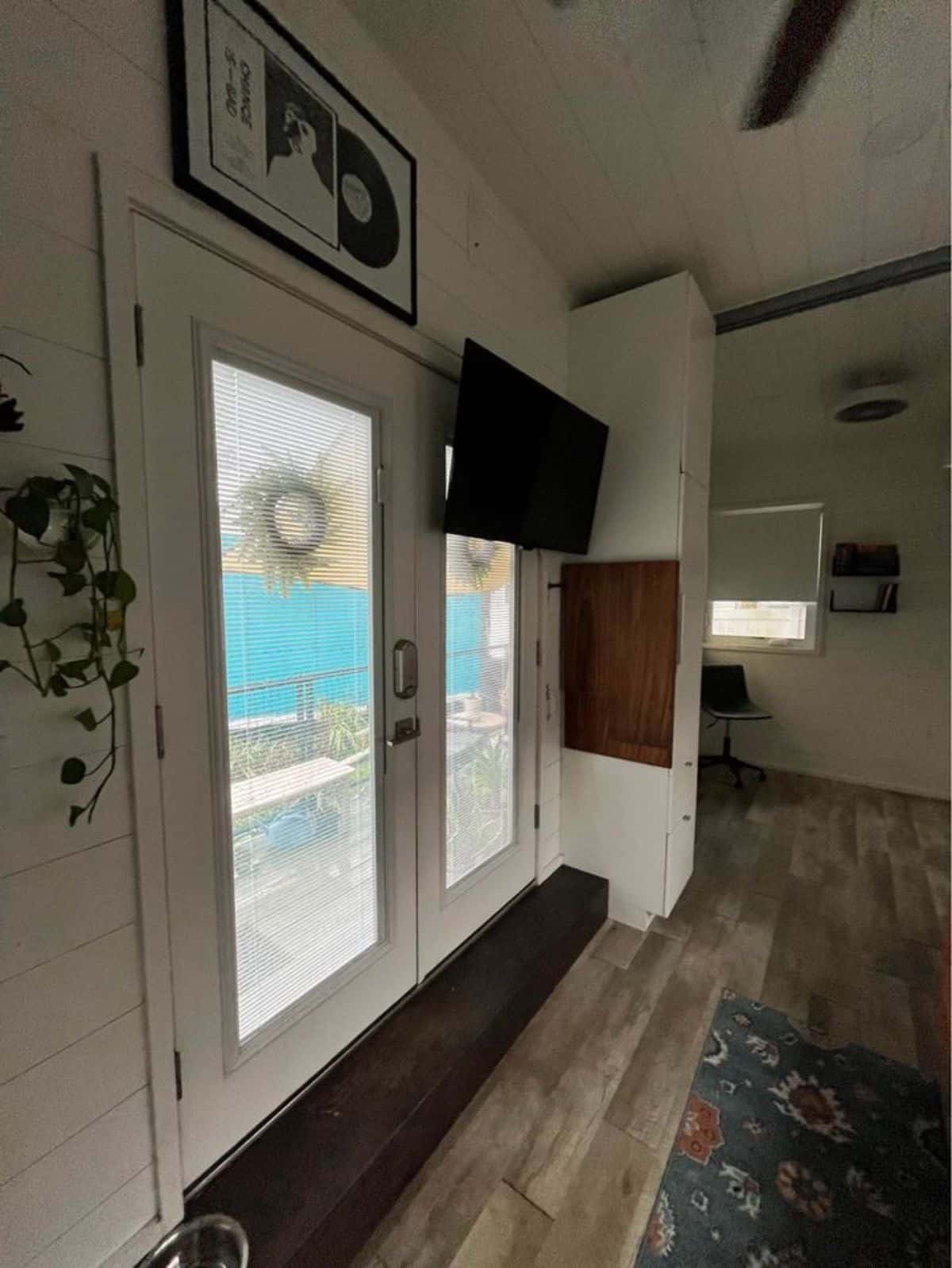 white walls and vinyl flooring all over the tiny house in lakefront community