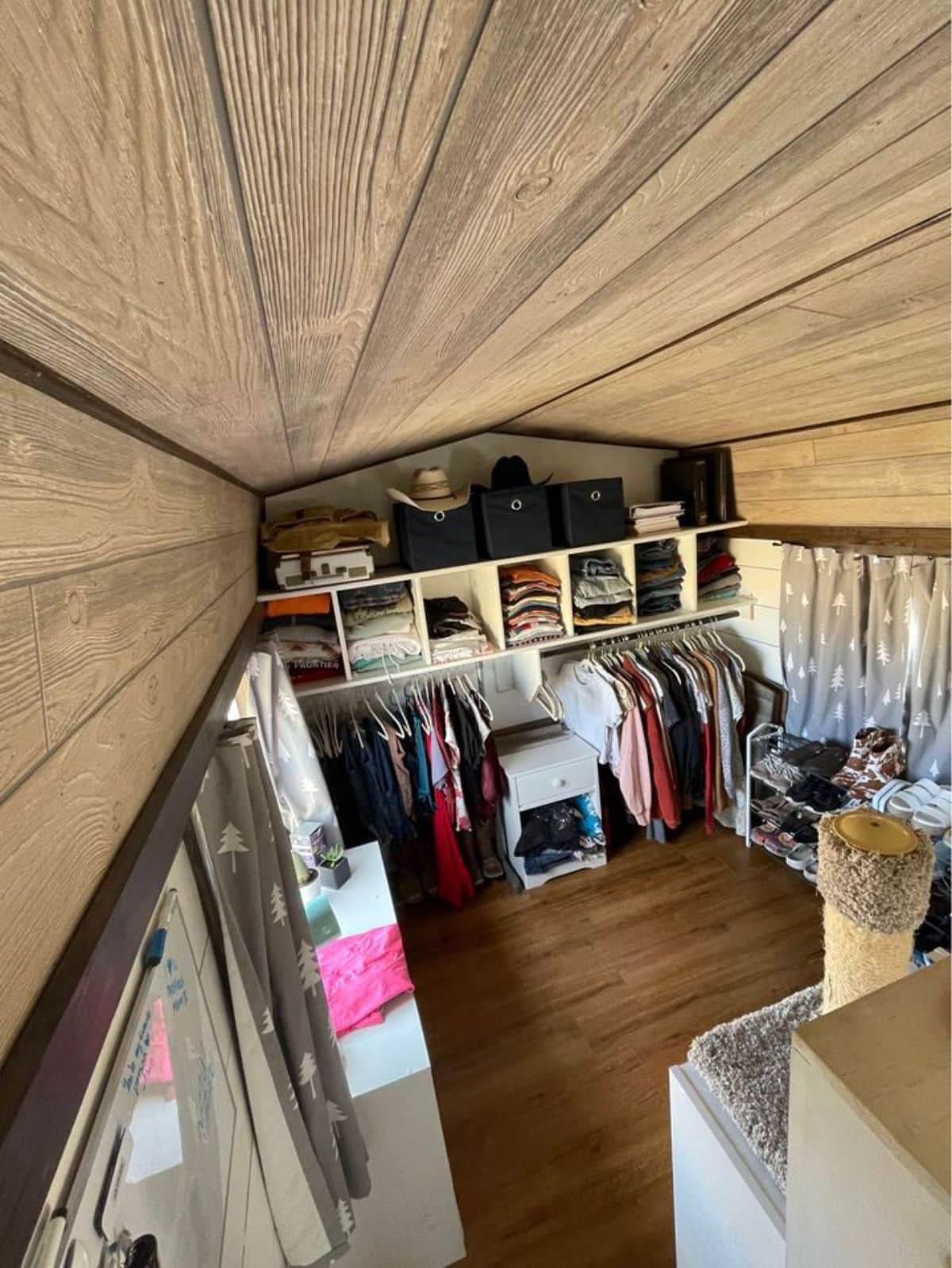 wardrobe behind the living area of tiny home for a couple