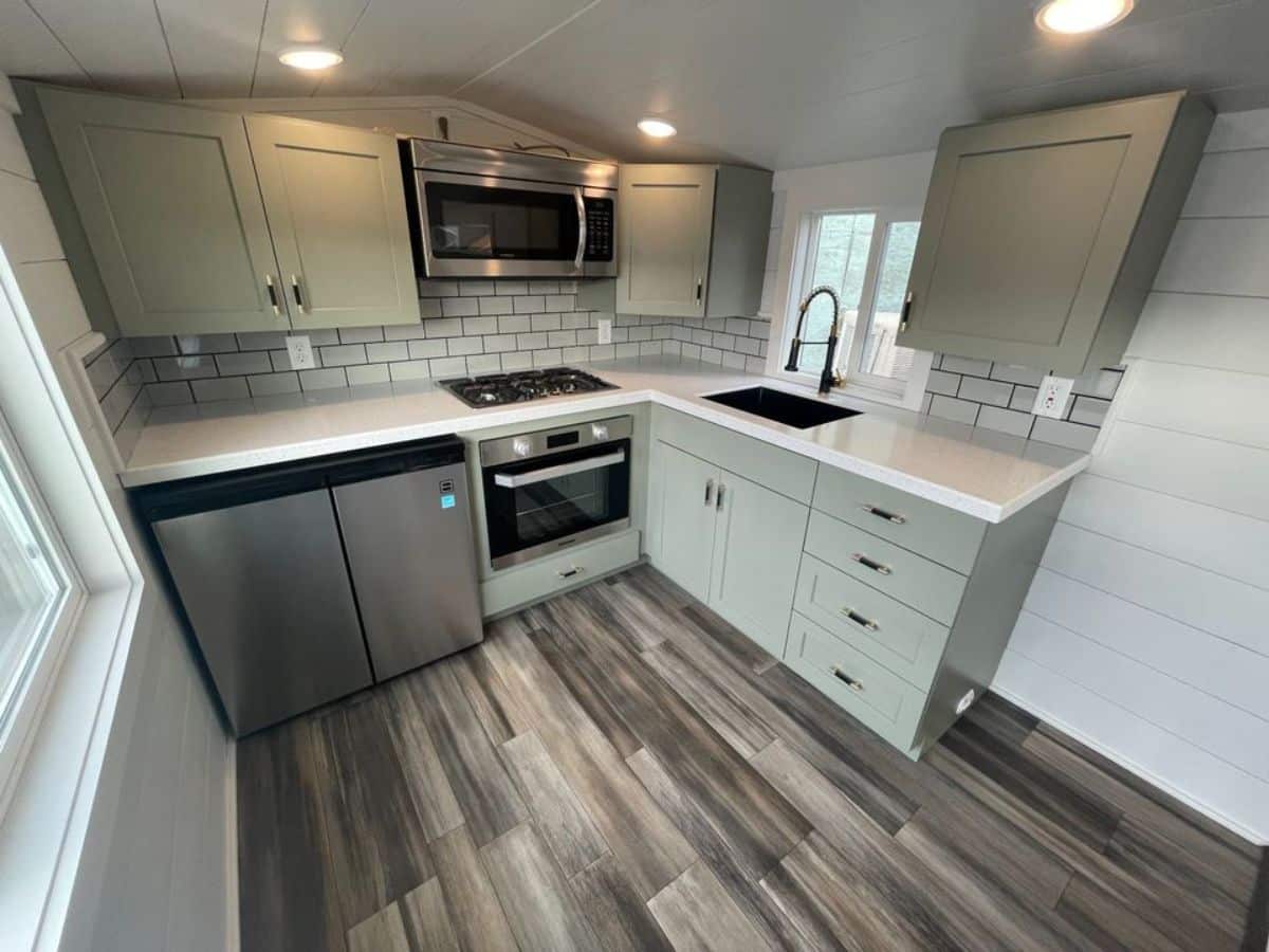 super stylish kitchen area of tiny RV home has ample space for dining table too