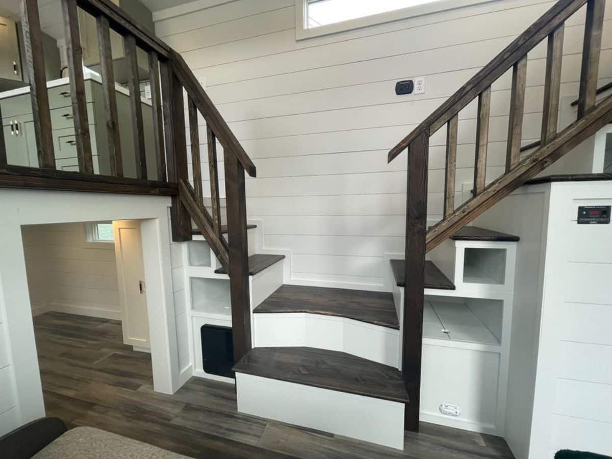 two multi purpose stairs leading to kitchen and loft bedroom of tiny RV home