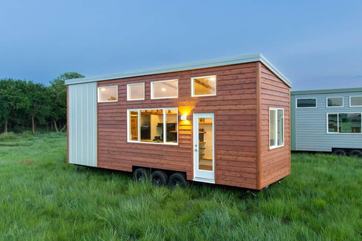 Stunning white and brown exterior of one bedroom tiny home on wheels