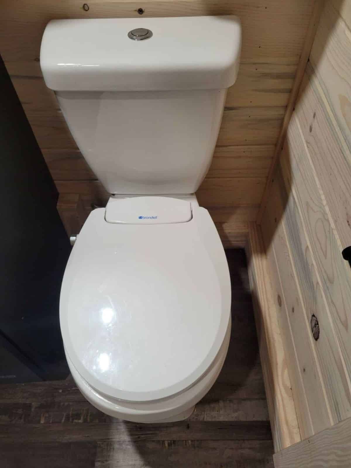standard toilet in bathroom of modern tiny house