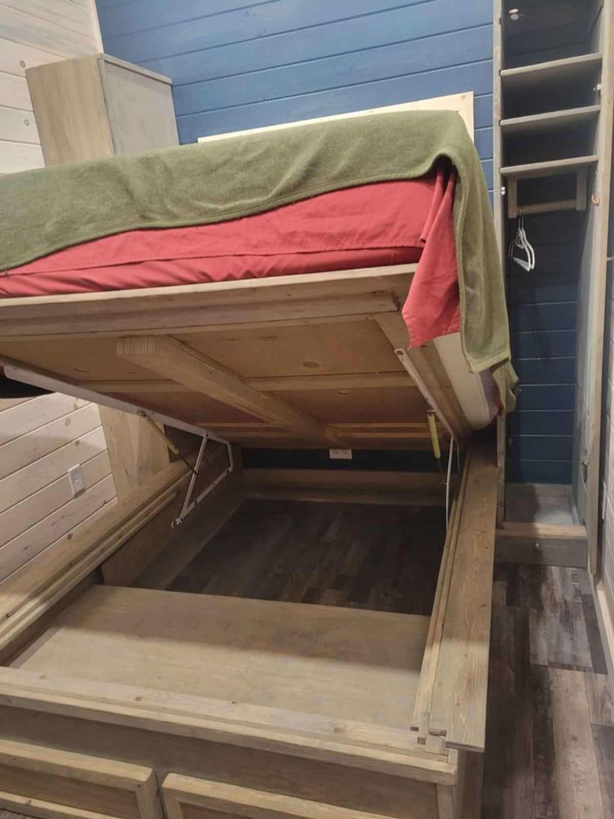 bed in the bedroom has a huge storage space underneath