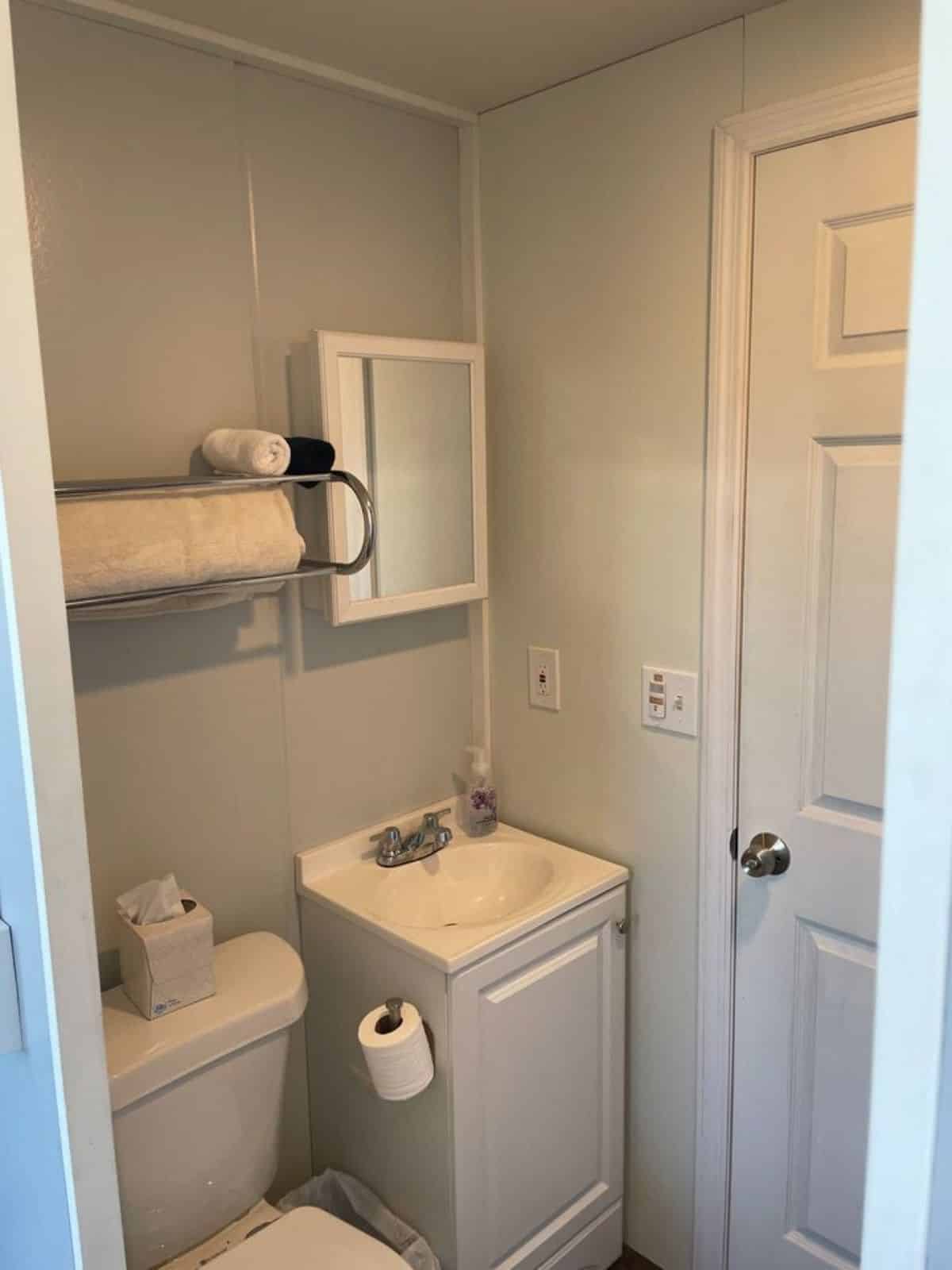 sink with vanity and mirror in the bathroom of tiny home on wheels