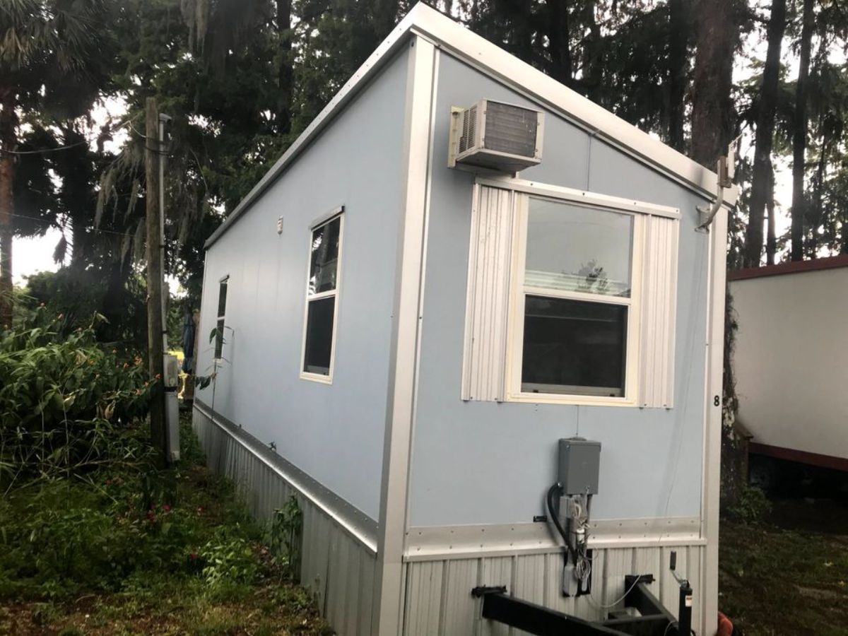 backside with multiple windows of tiny home on wheels