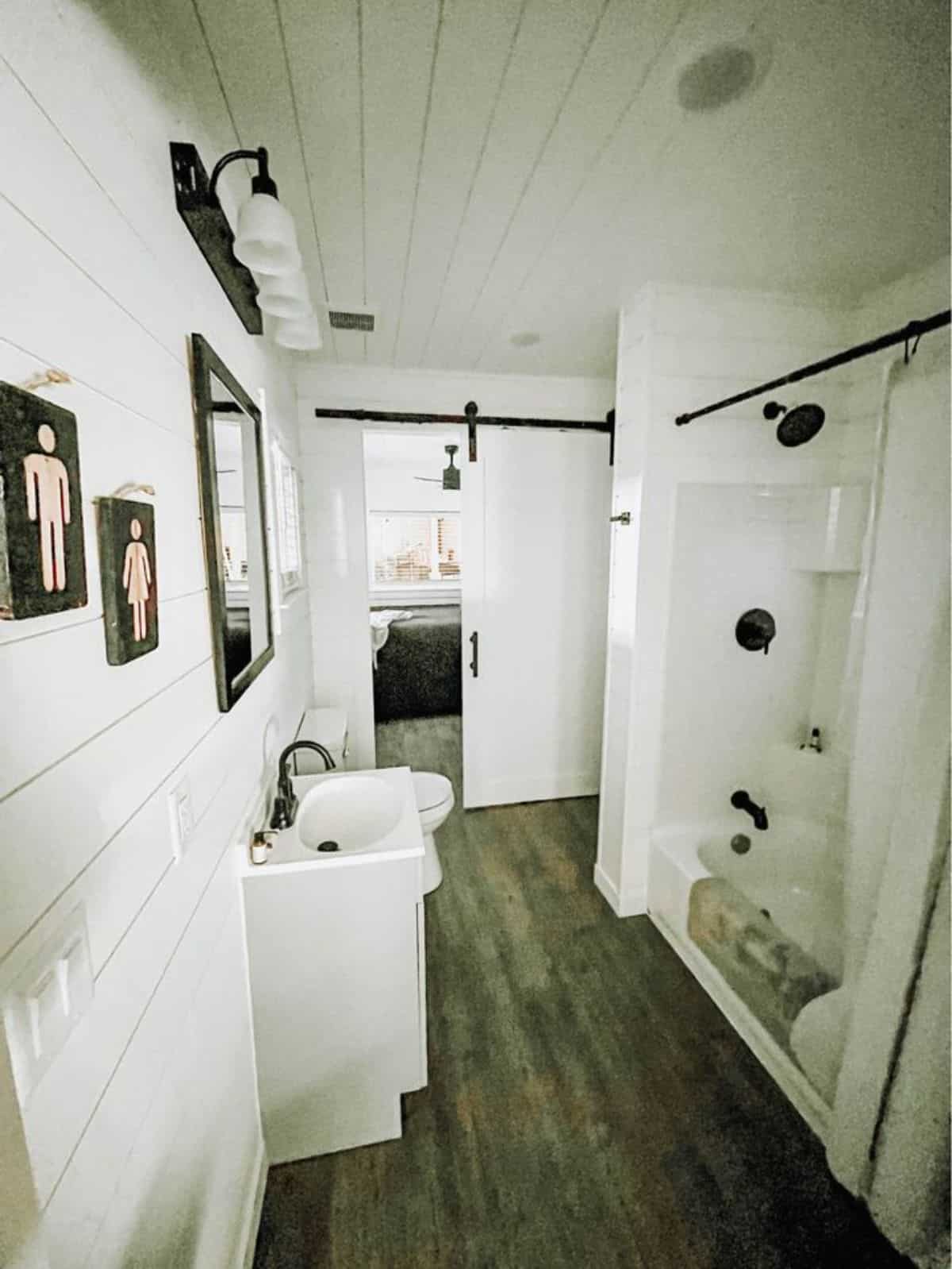 bathroom of move-in ready tiny home has a bath tub and all standard fittings