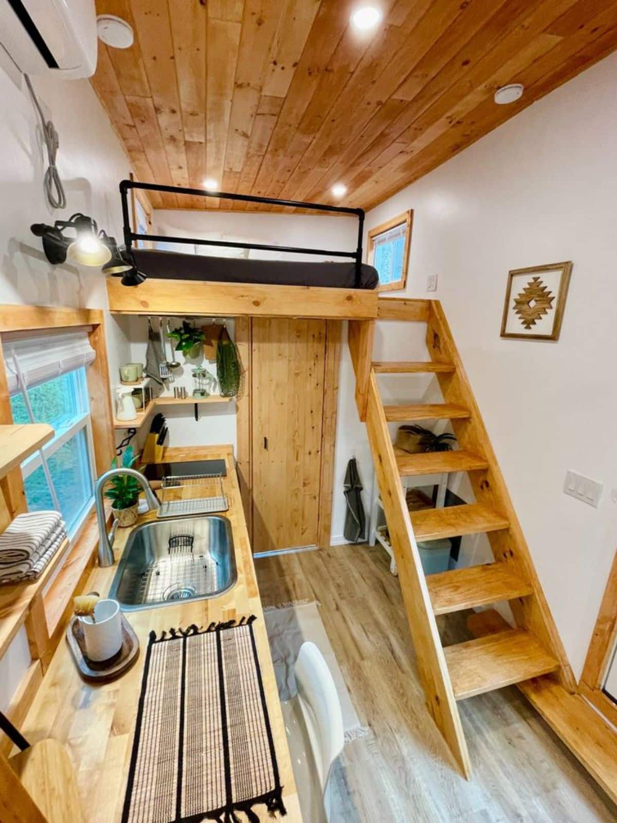 ladder leading to the loft above the bathroom of brand new tiny house