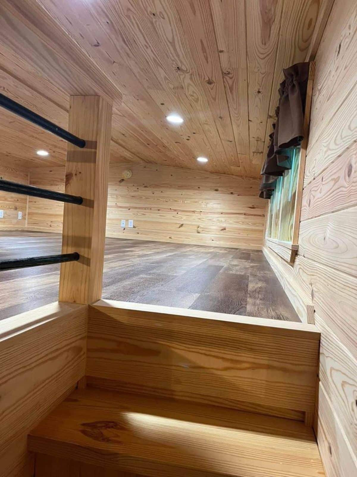 Loft bedroom of custom cabin home is spacious