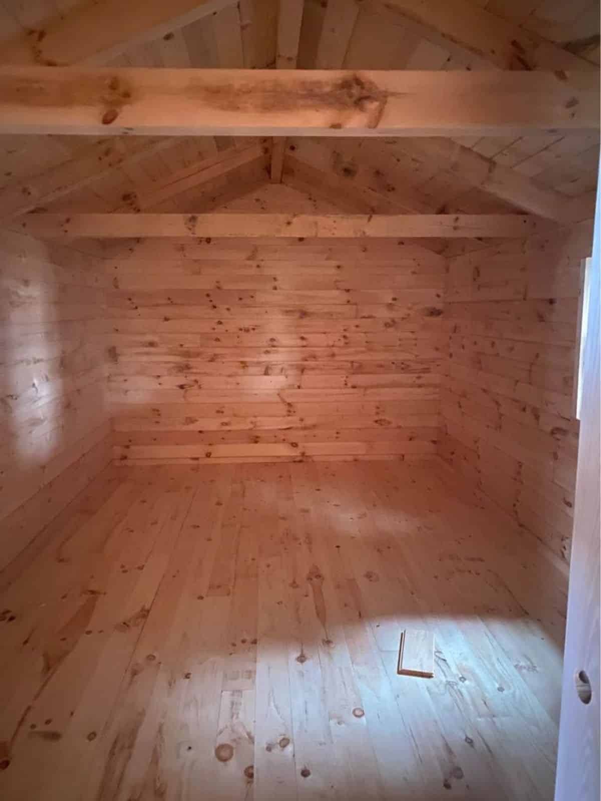 Wooden living cum sleeping area of log cabin home