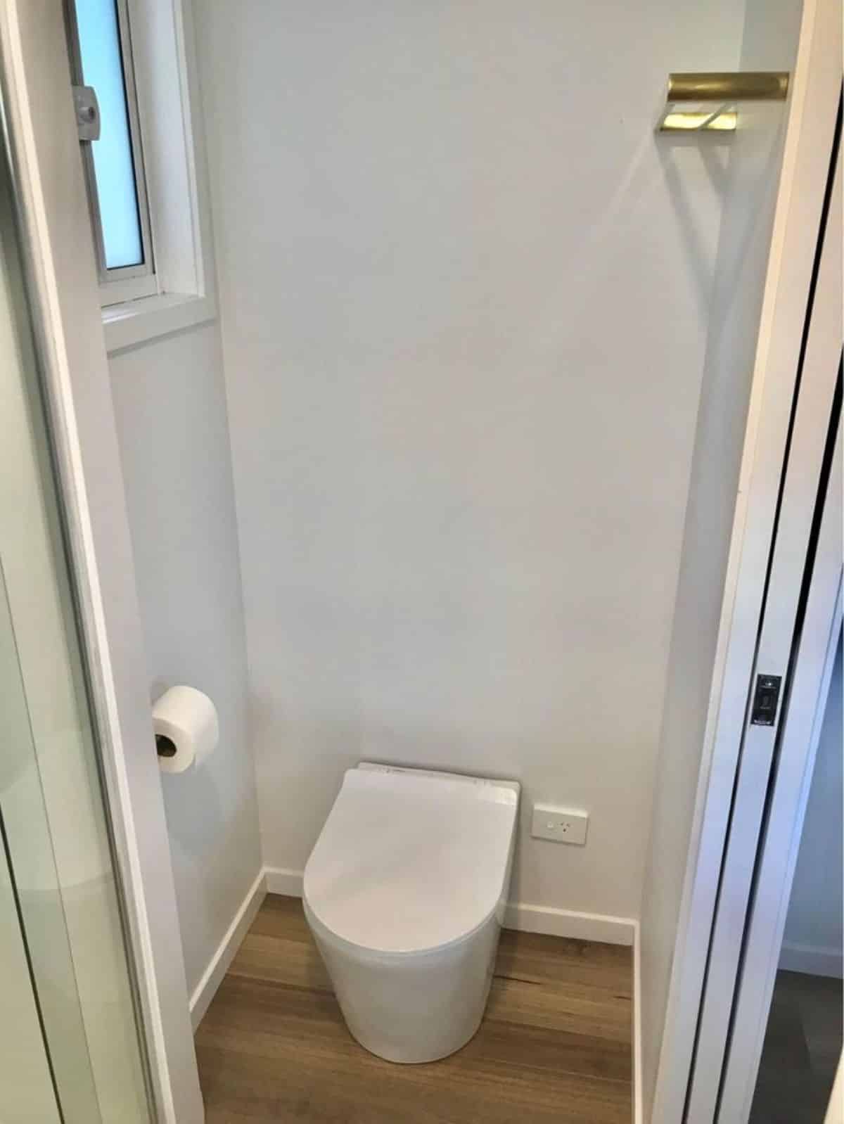 Composting toilet is installed in bathroom of furnished tiny house