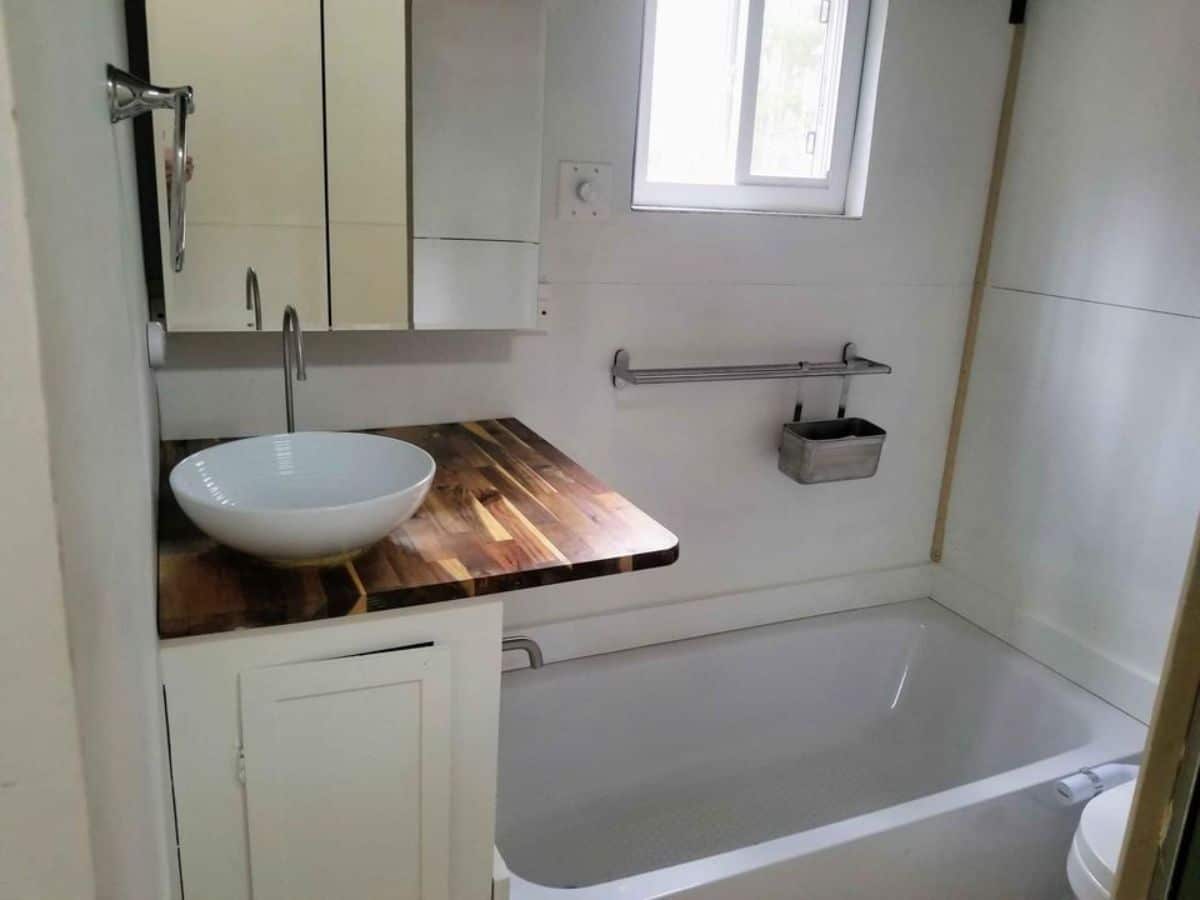 sink with vanity & mirror in bathroom of non toxic tiny home