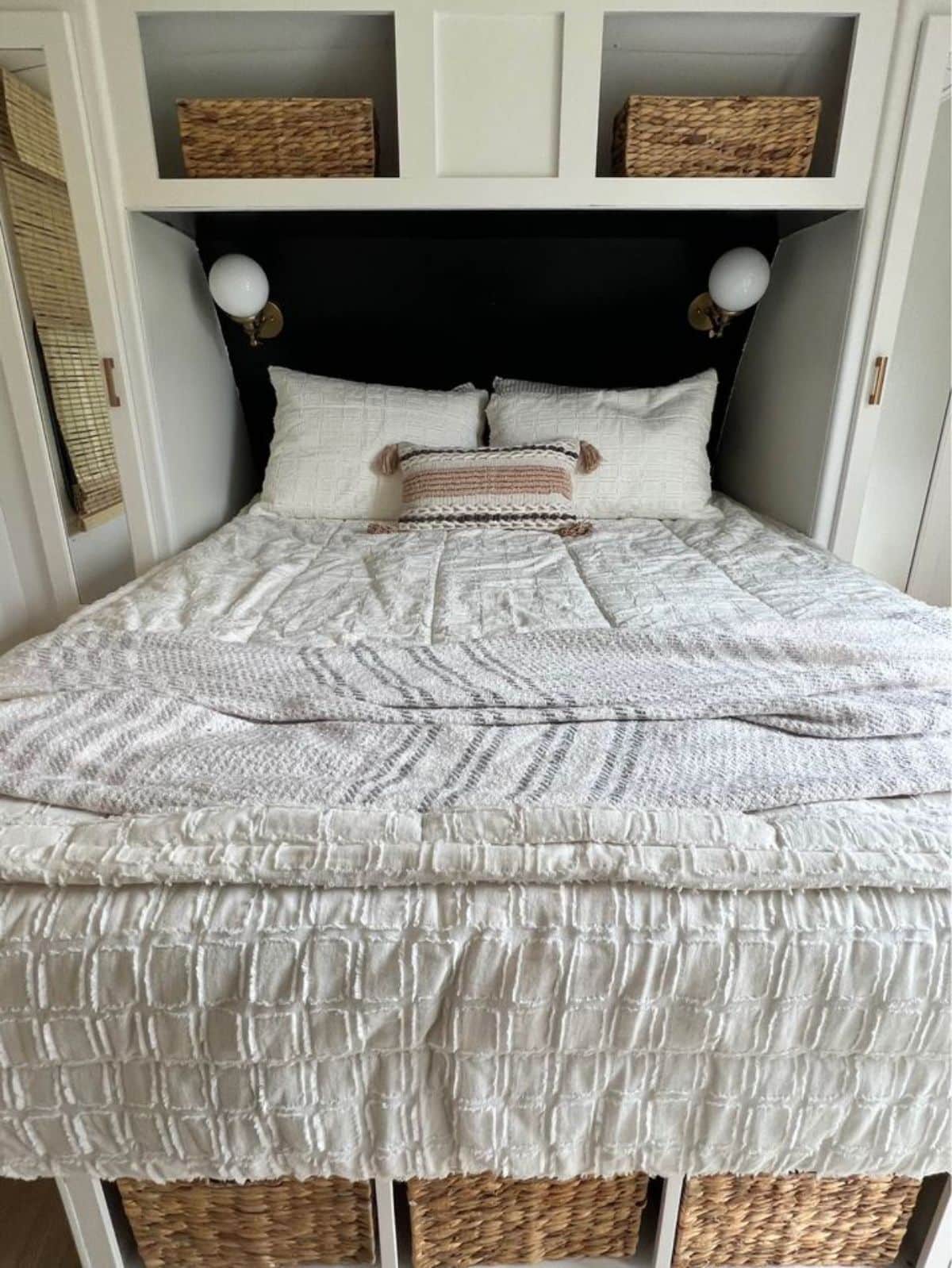 Super cozy bed installed in bedroom with side tables and storage