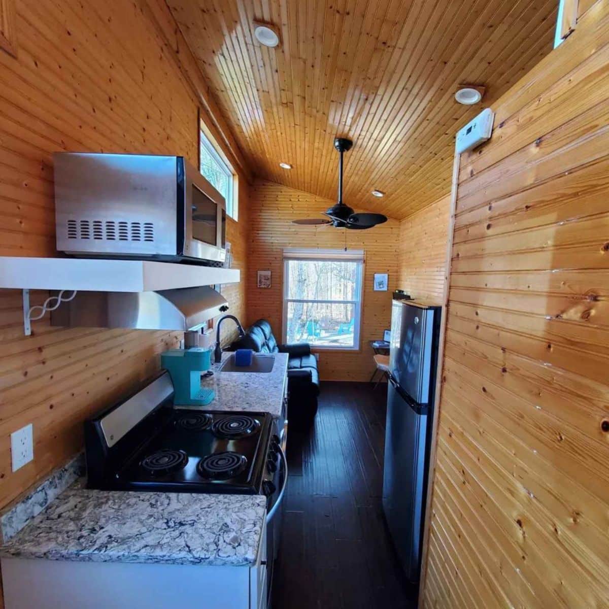 kitchen area of tiny home with downstairs bedroom