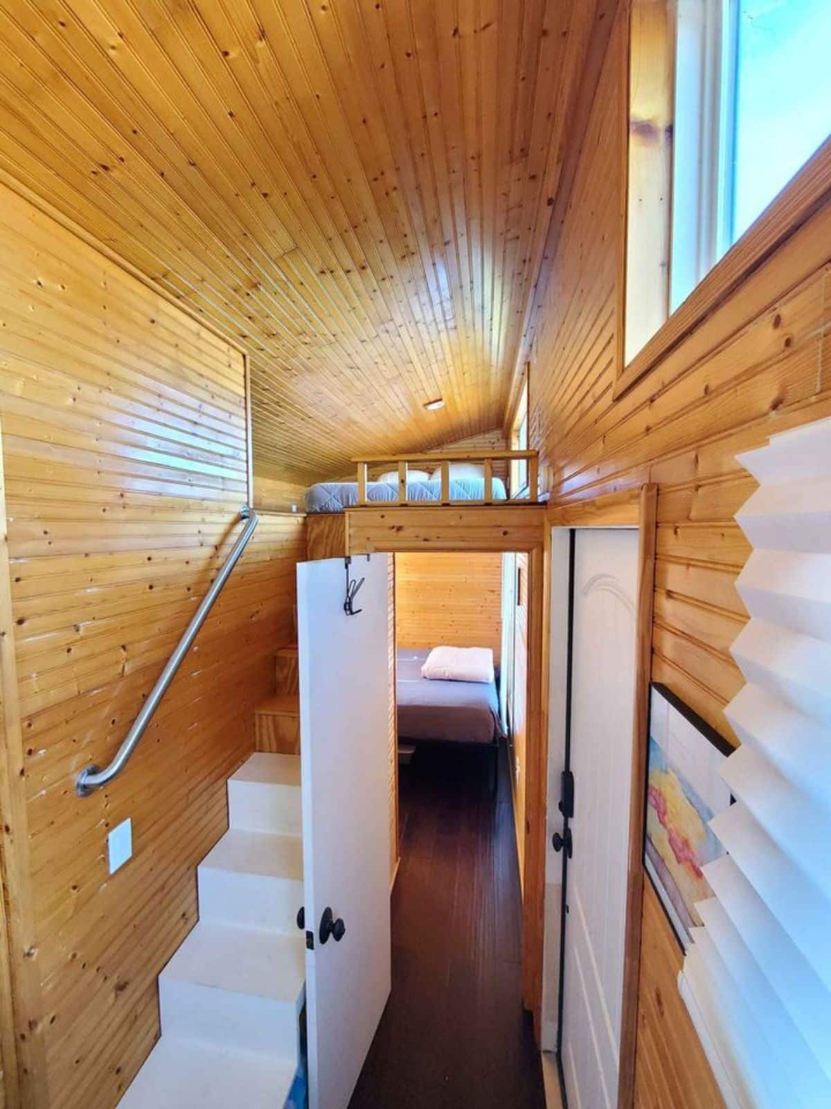 stairs leading to the loft above the main floor bedroom
