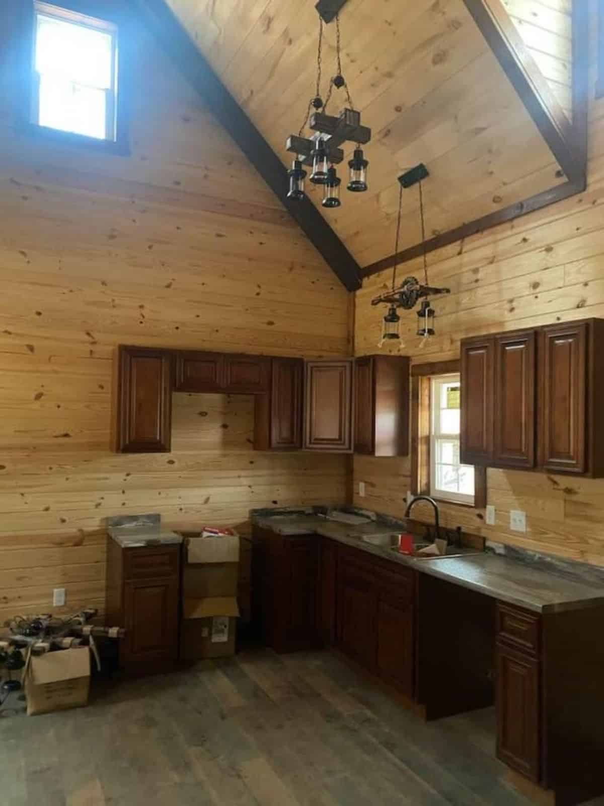 kitchen area of rustic version of two story cabin home