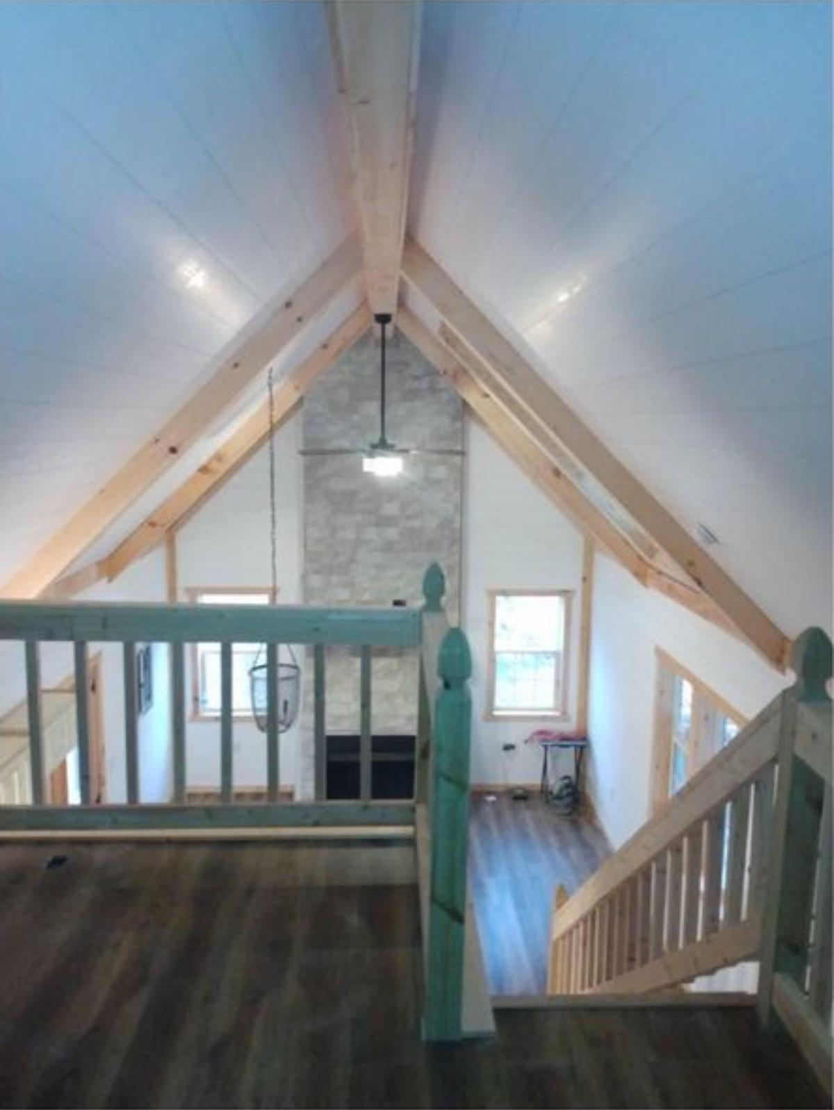 loft leading to the loft bedroom of two story cabin home