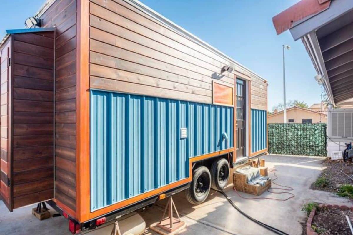 stunning blue and brown exterior of 20' budget tiny house