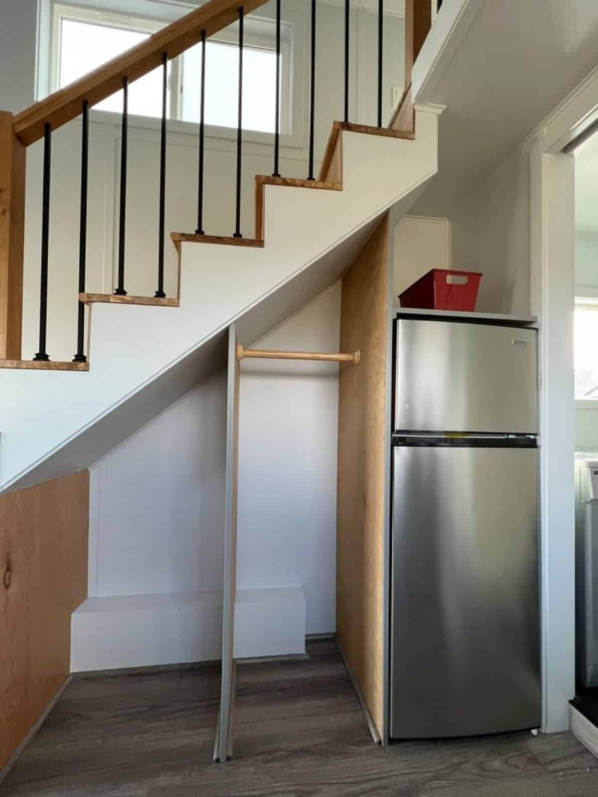 storage underneath the stairs has double door kitchen