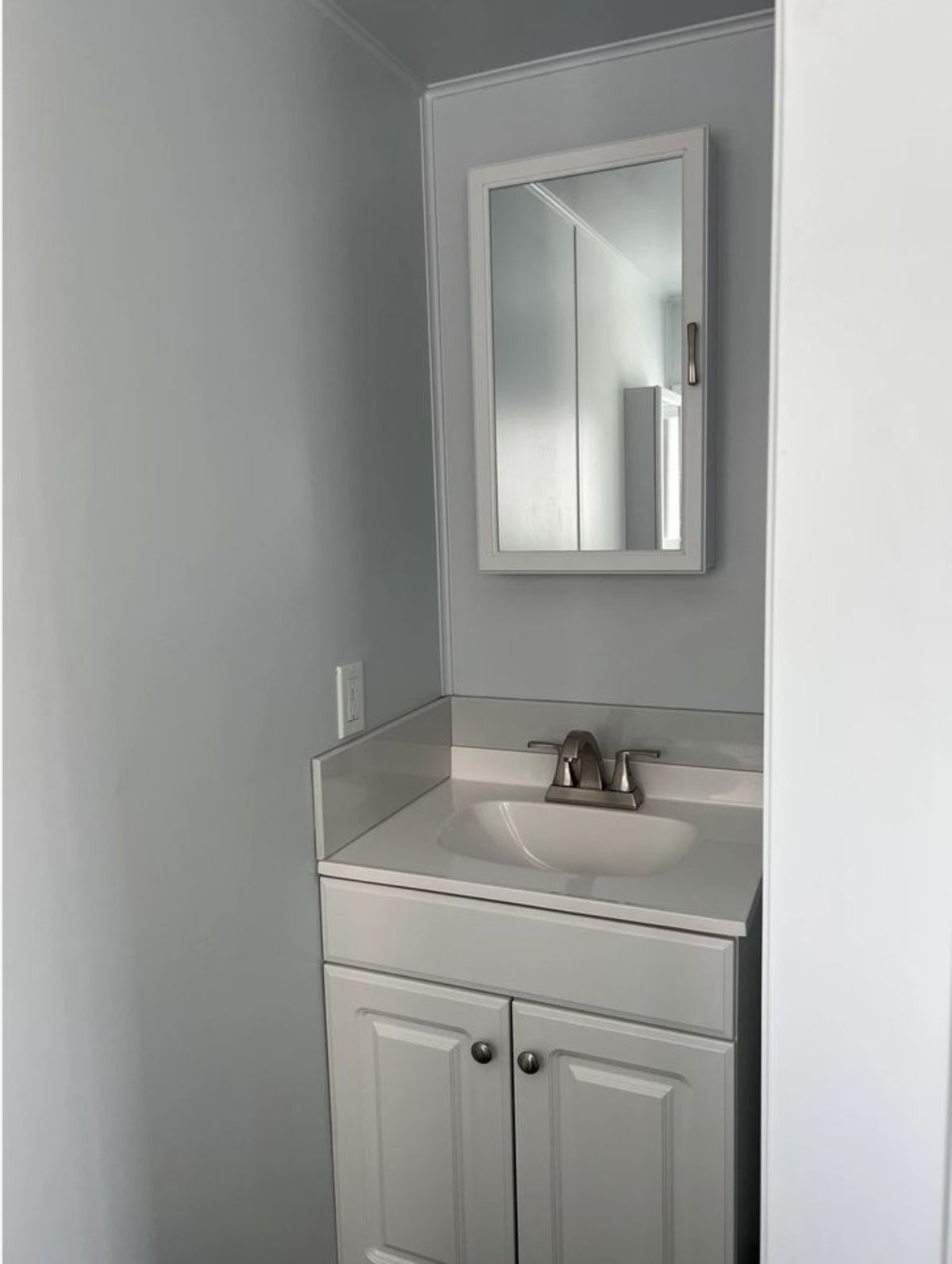 sink with vanity & mirror in bathroom