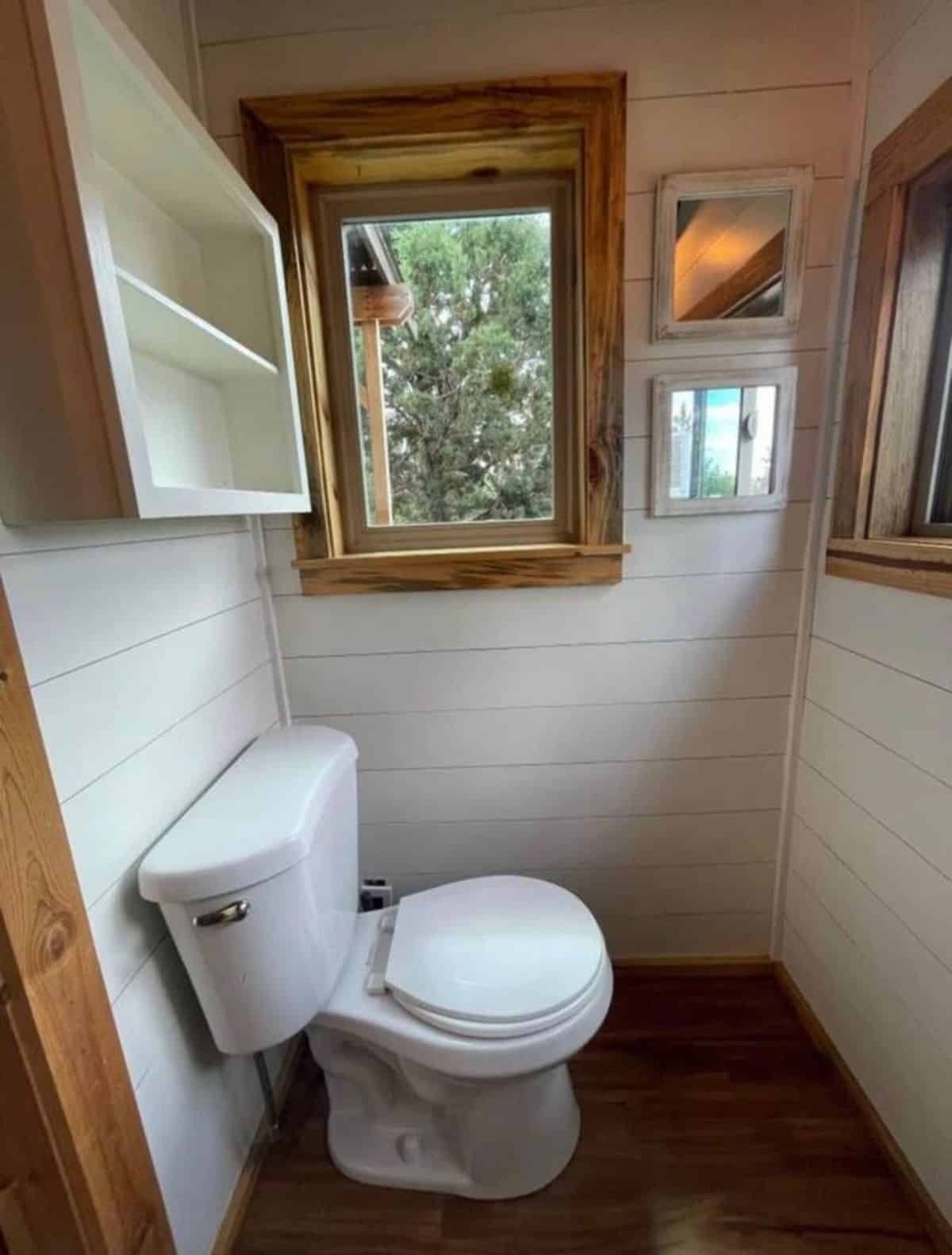 standard toilet in bathroom of 23’ tiny house