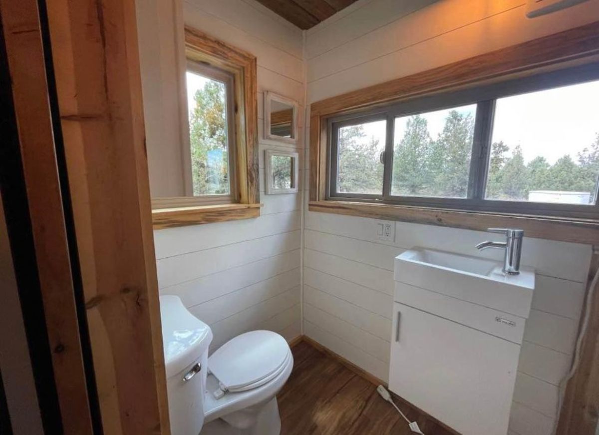 huge windows in the bathroom  alongside  sink with vanity