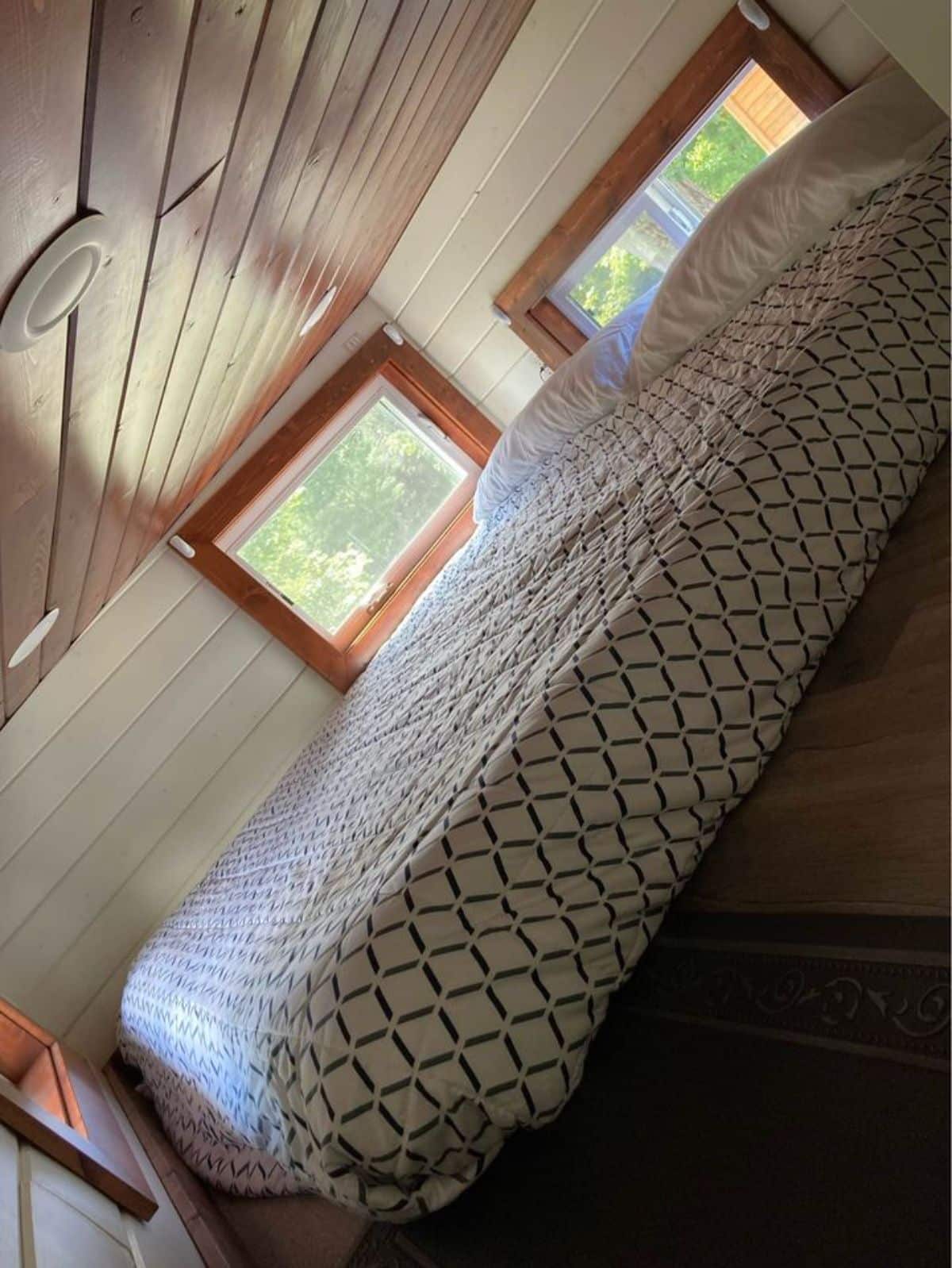 comfortable mattress on the loft of custom made tiny home