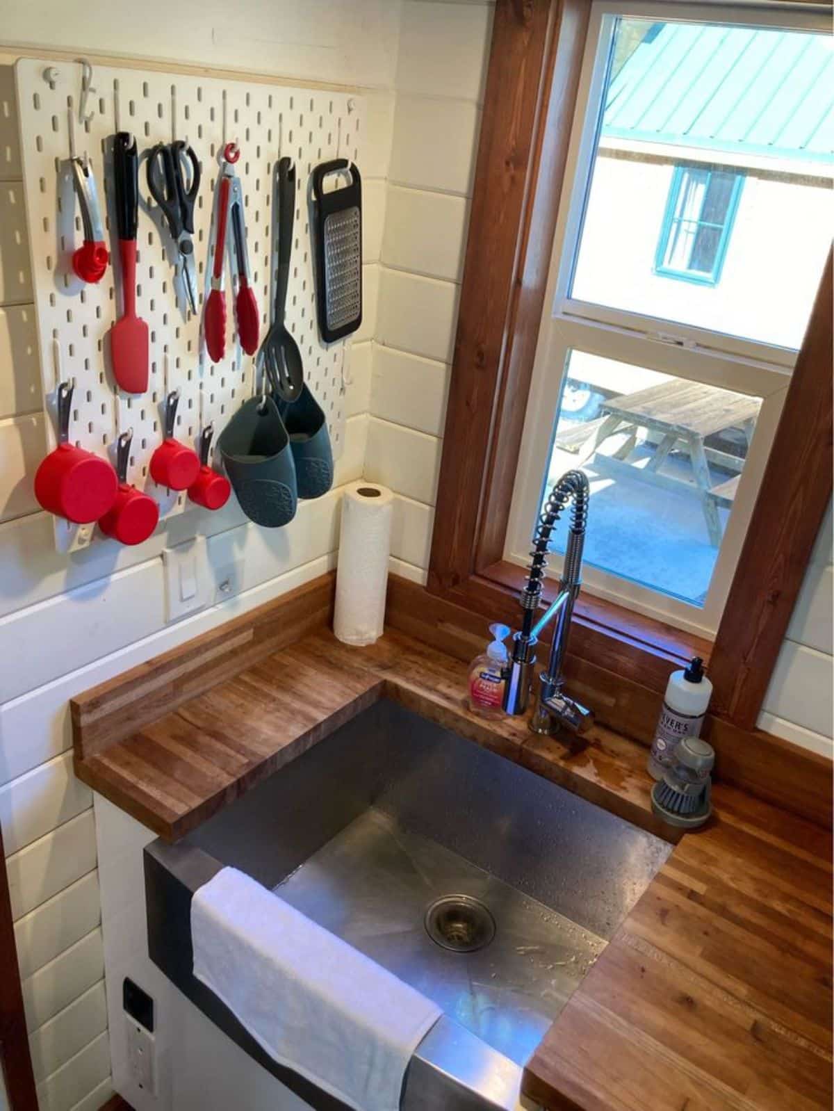 stainless steel sink besides the window in kitchen area