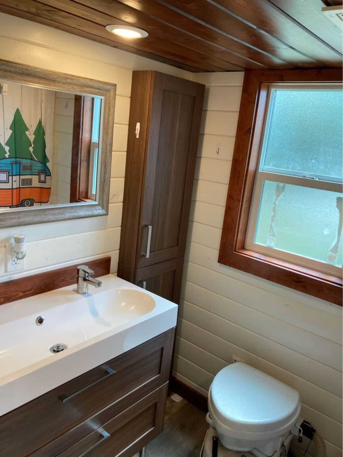 bathroom of custom made tiny home has all the standard fittings