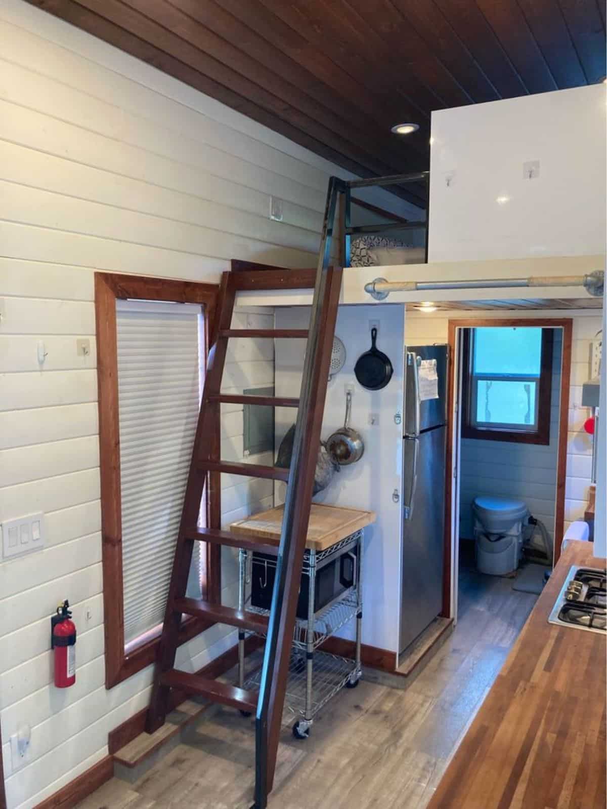 ladder leading to the loft bedroom of custom made tiny home