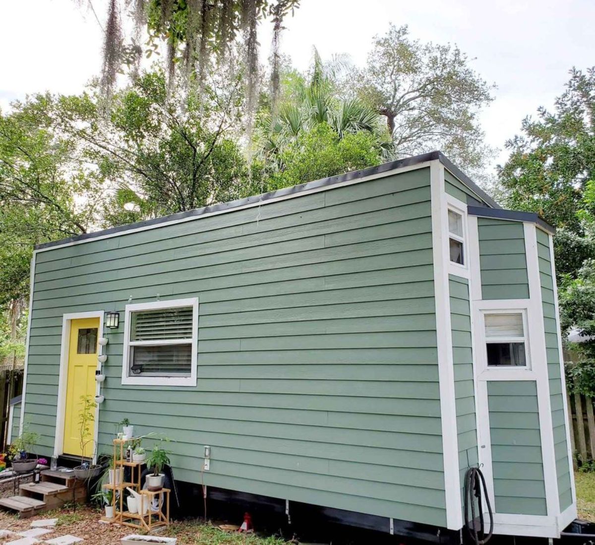 stunning olive green exterior with main entrance view of 24' one bedroom tiny house